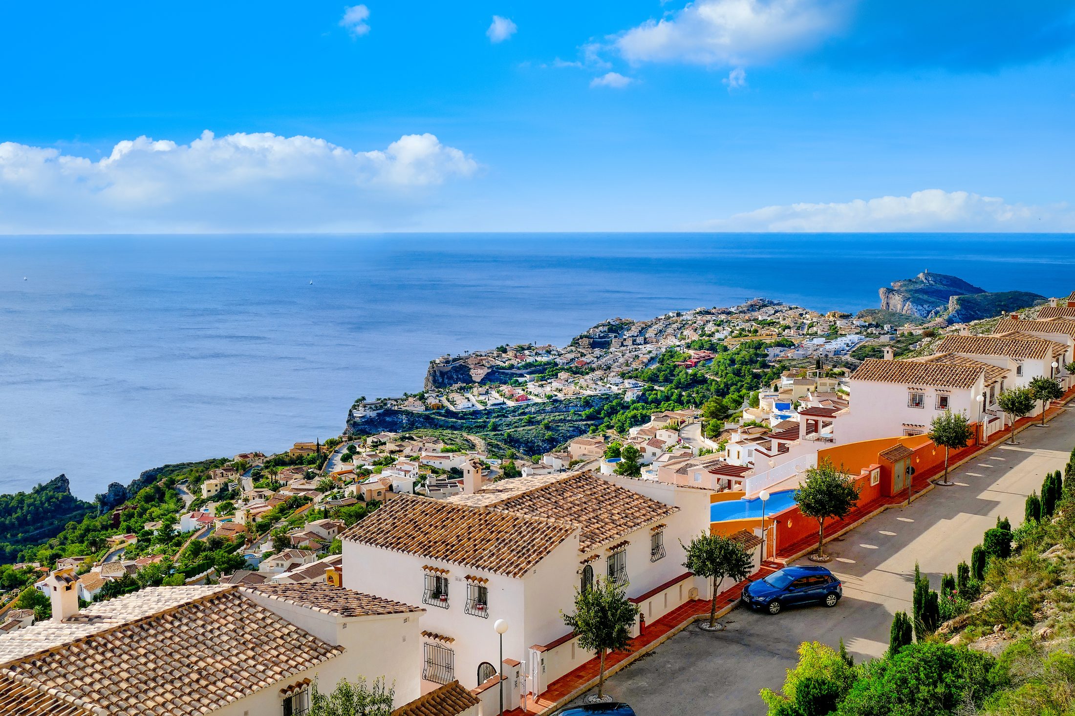 Street of the pueblo on Cumbre del Sol above the coastline