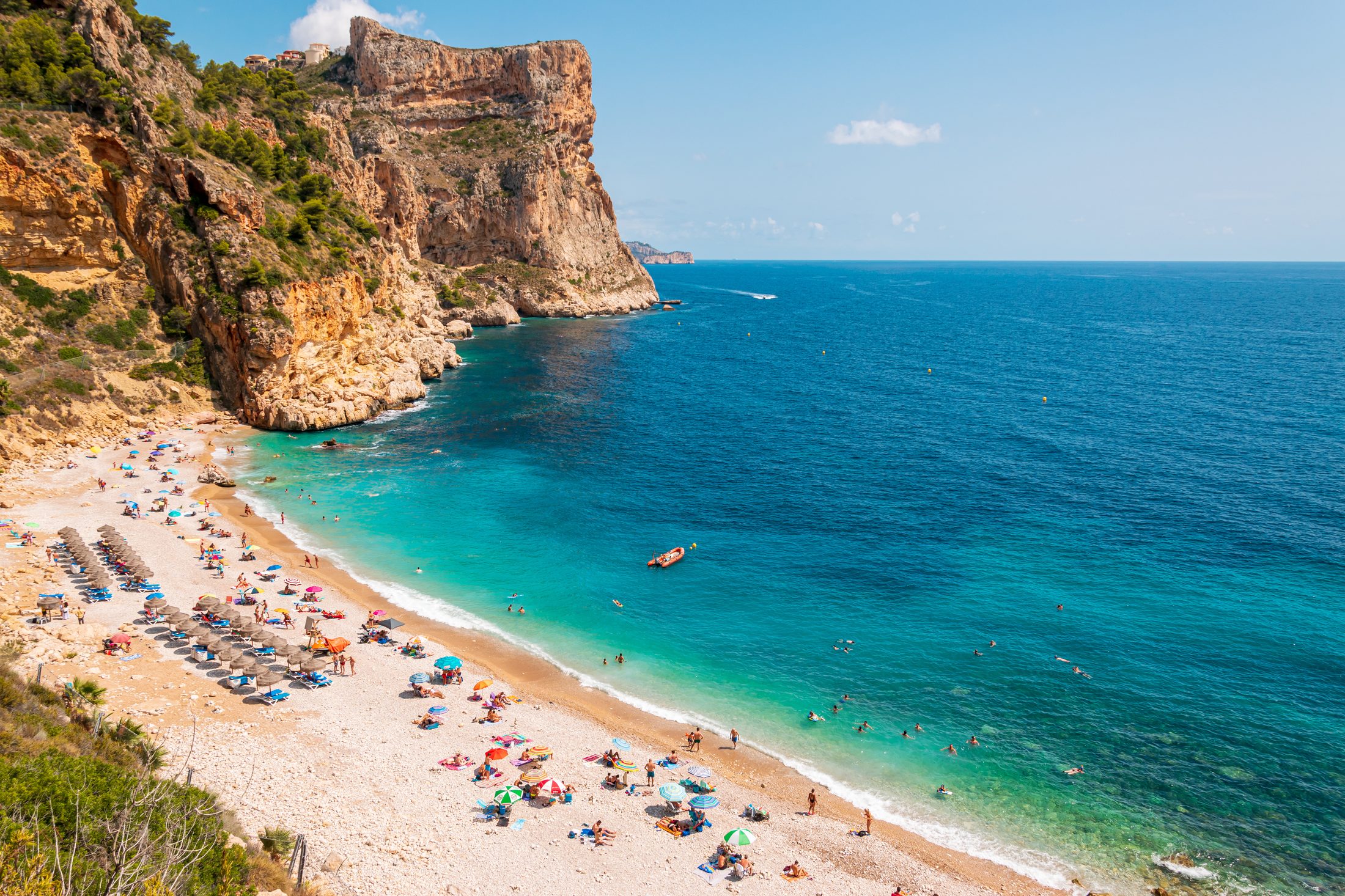 Cala del Moraig cove with turquoise water under high cliffs