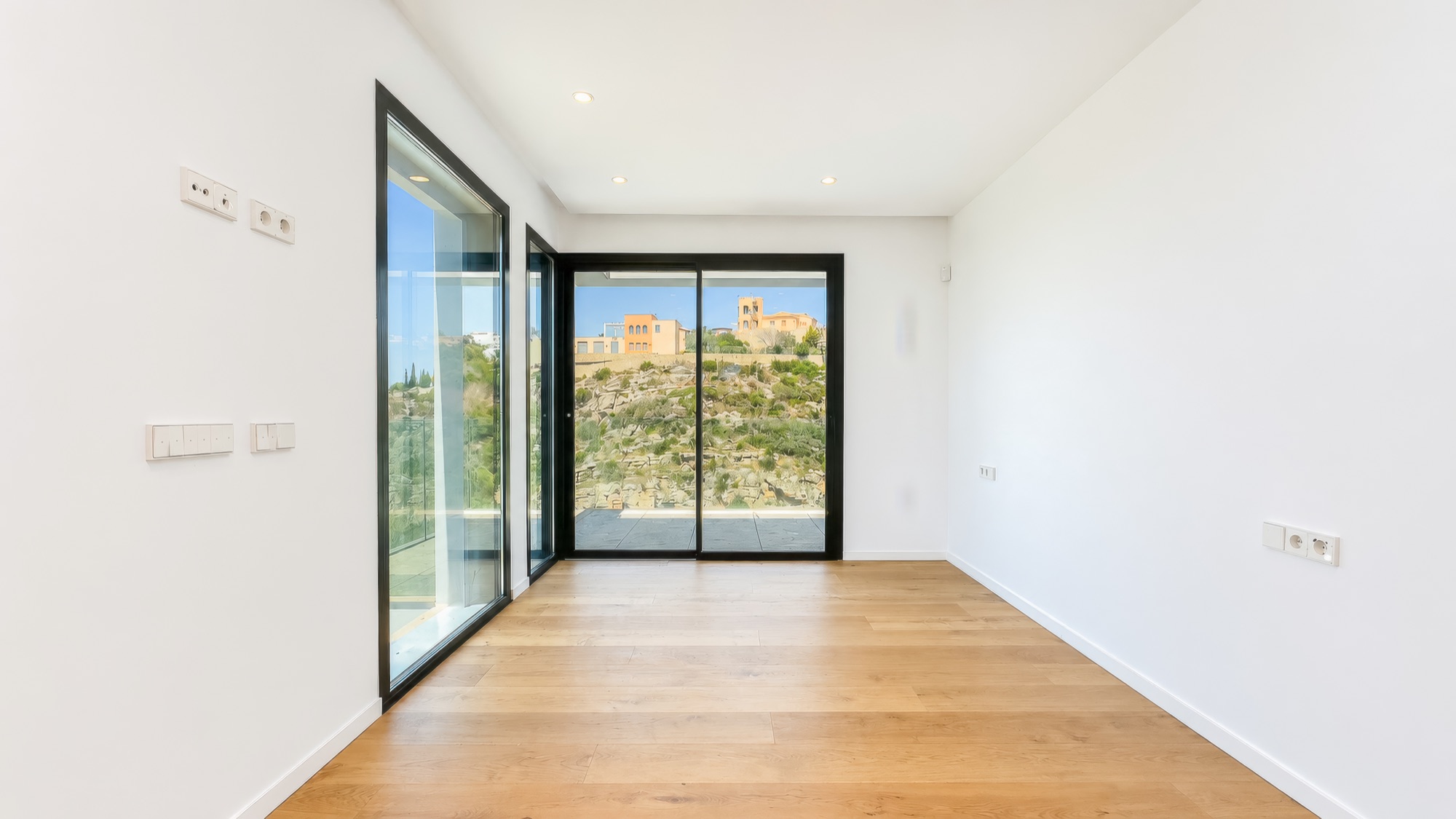 Upper-floor suite with corner windows and oak parquet