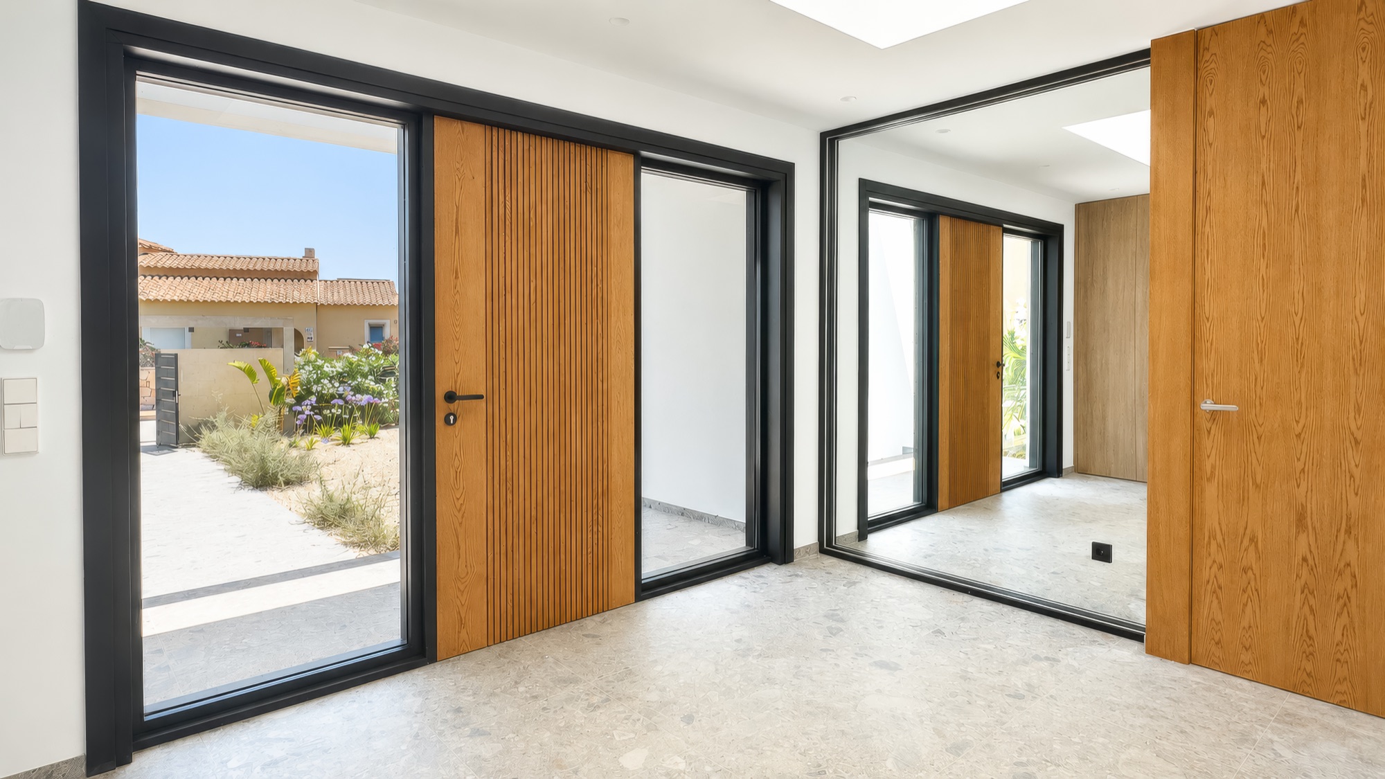 Entry hall with oak doors, mirror and terrazzo floor